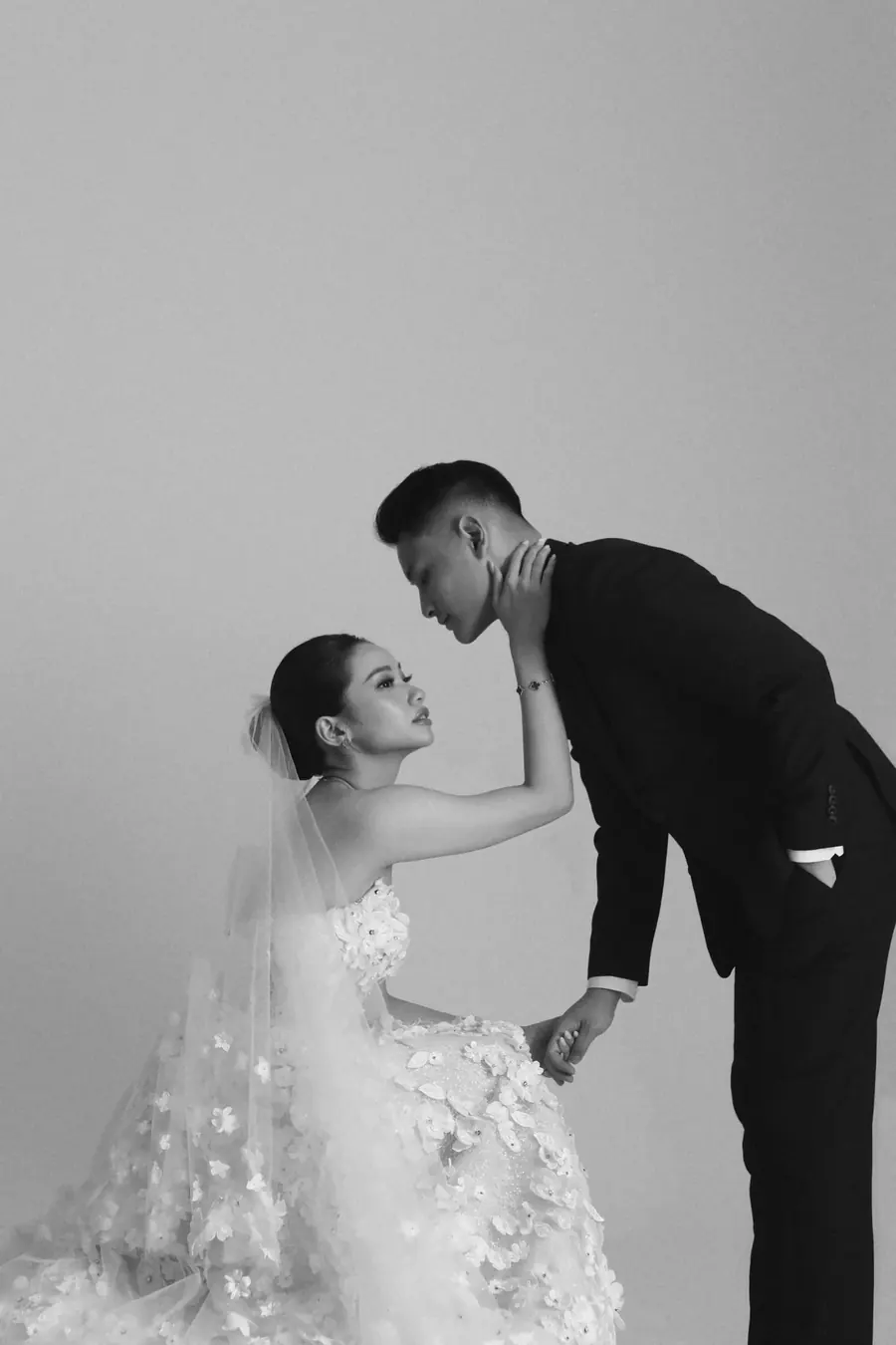 Matthew leaning down to Karin, who sits in her veil and gown