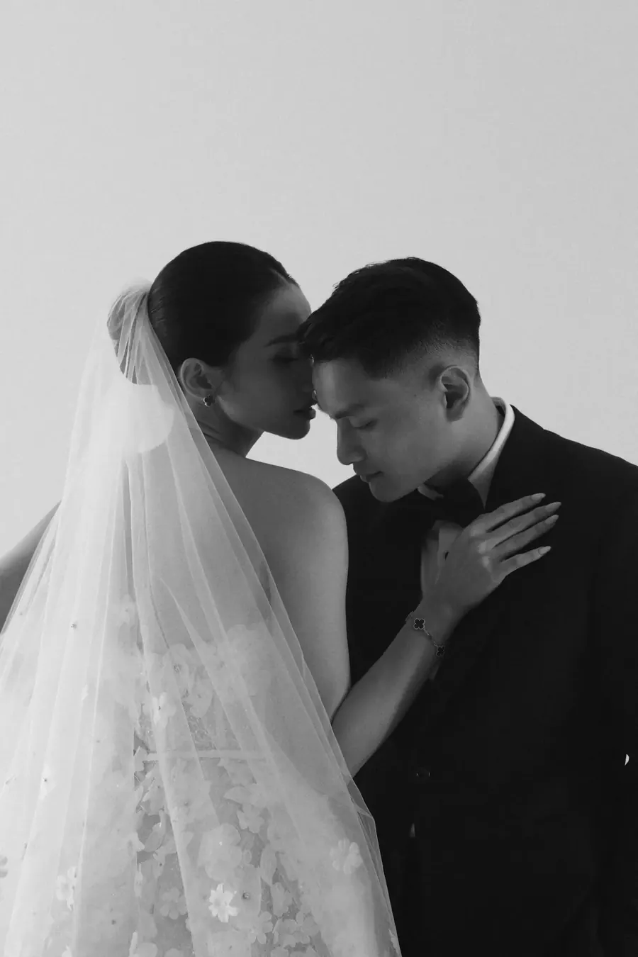 Matthew and Karin close together beneath her veil
